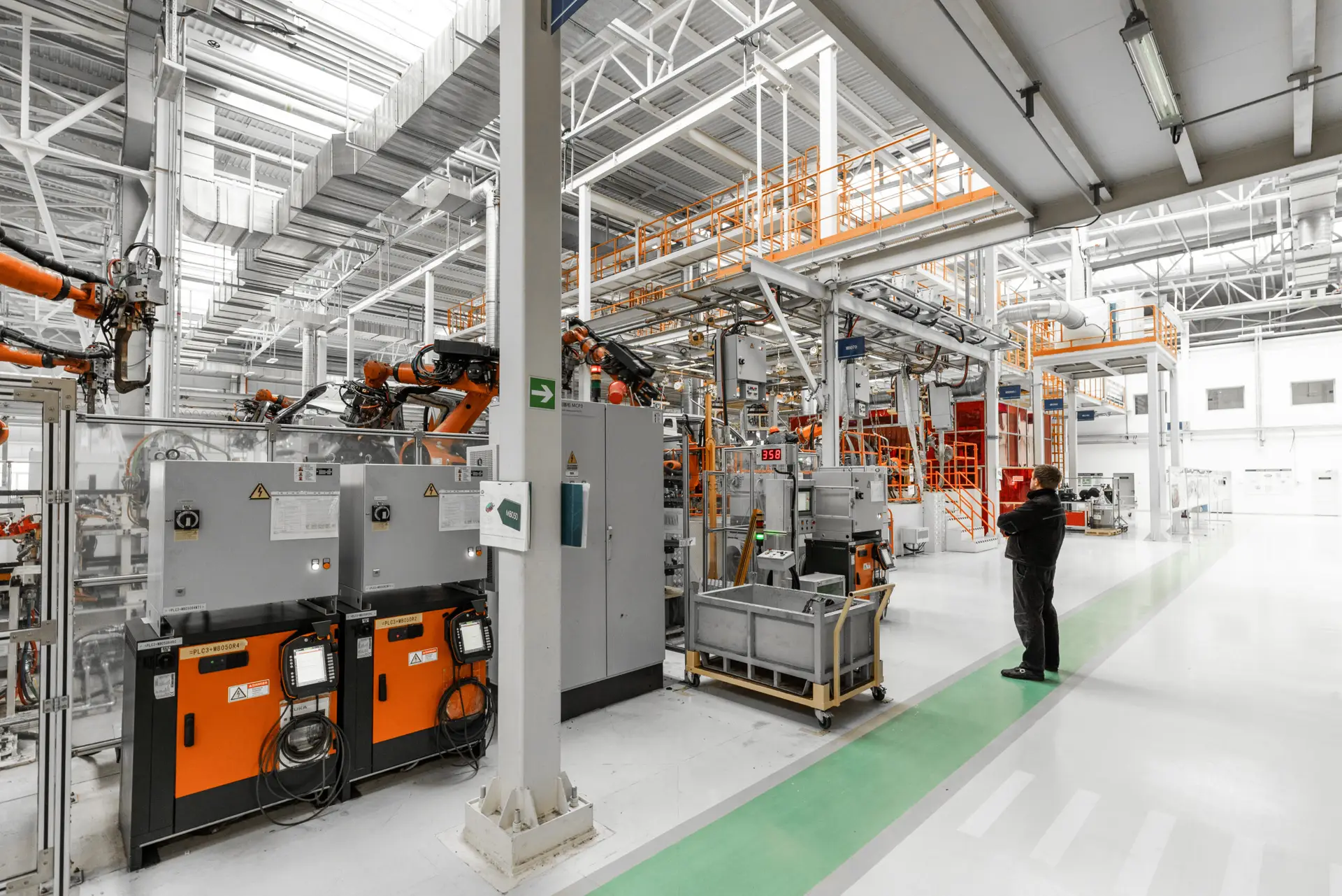 Photo of automobile production line. Welding car body. Modern car assembly plant. Auto industry. Interior of a high-tech factory, modern production.